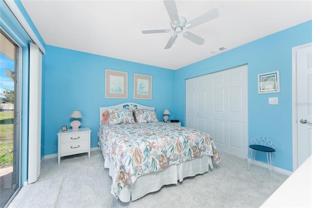 bedroom featuring light colored carpet, a closet, visible vents, and multiple windows