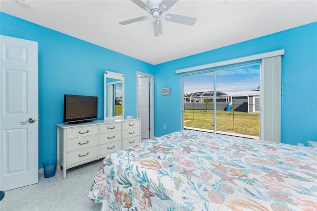 bedroom featuring access to exterior, light colored carpet, and ceiling fan