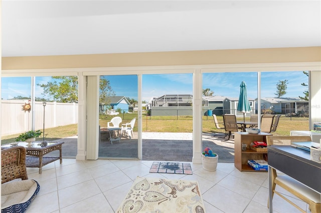 sunroom featuring plenty of natural light and a residential view