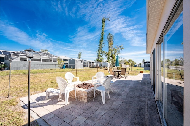 view of patio / terrace featuring a fire pit, fence, and a residential view