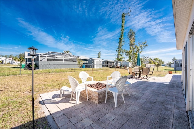 view of patio featuring an outdoor fire pit, a fenced backyard, and a residential view