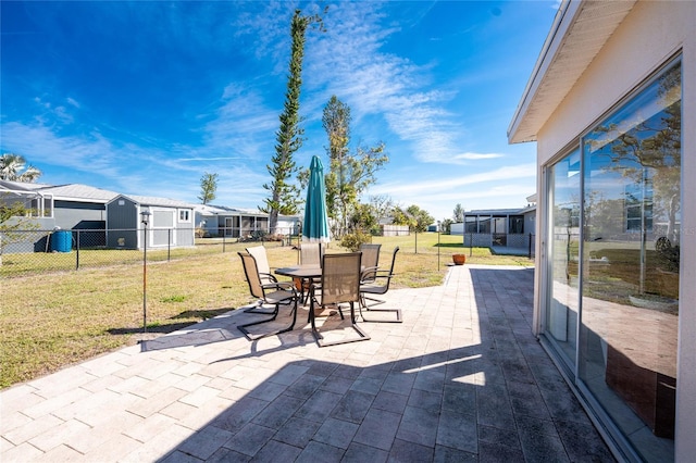 view of patio / terrace with outdoor dining area, a fenced backyard, and a residential view