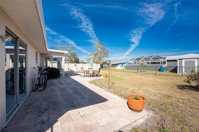 view of yard with a patio area, a fenced backyard, and a residential view