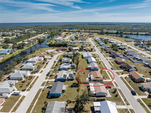 drone / aerial view featuring a water view and a residential view