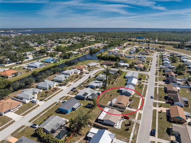 bird's eye view with a water view and a residential view