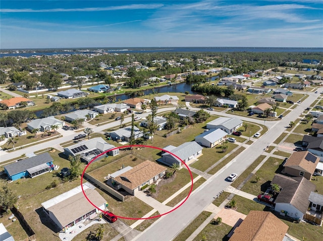 birds eye view of property featuring a residential view and a water view