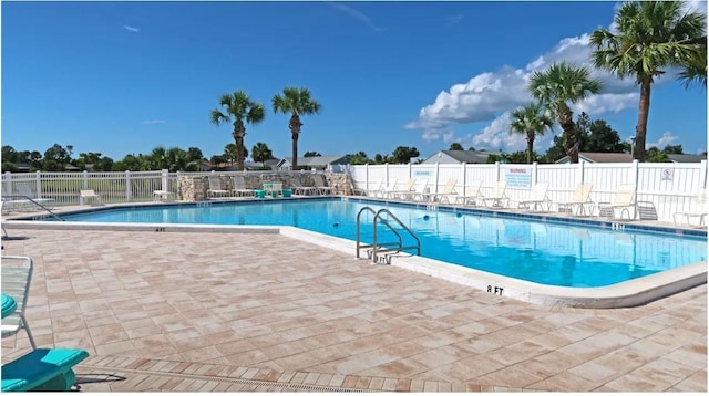 pool with fence and a patio