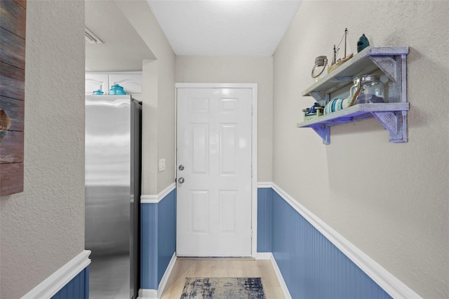 doorway with wood-type flooring