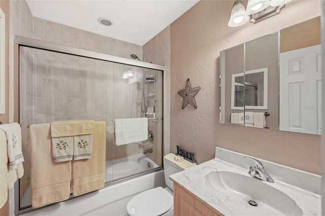 full bathroom with vanity, enclosed tub / shower combo, and toilet