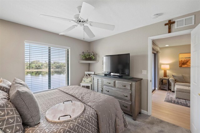 bedroom featuring light carpet and ceiling fan