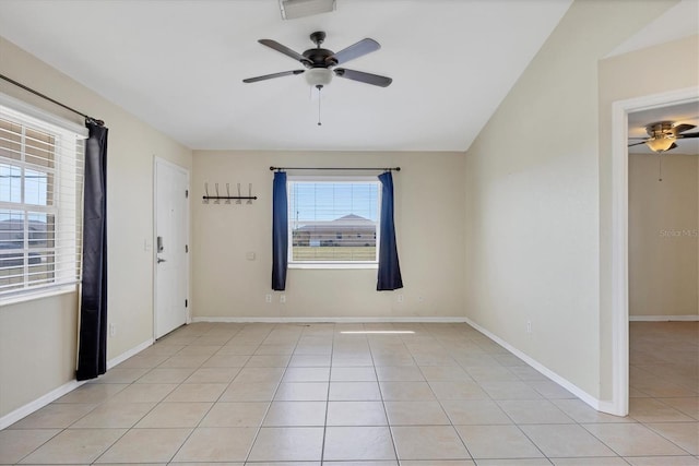 tiled spare room with ceiling fan