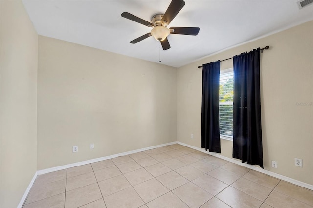 tiled spare room featuring ceiling fan