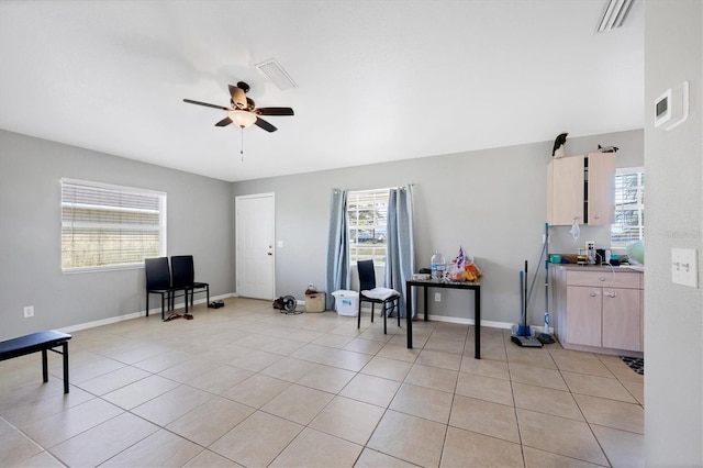 living area featuring light tile patterned floors and ceiling fan