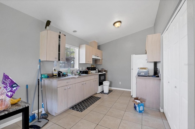 kitchen with sink, light tile patterned floors, and electric range