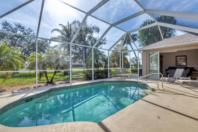 view of pool with a patio and glass enclosure