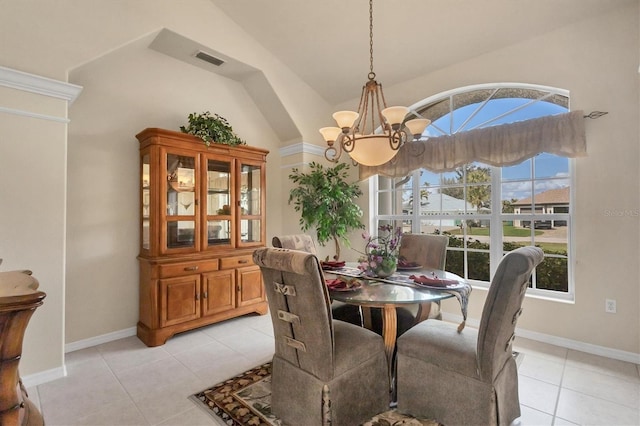 tiled dining room featuring vaulted ceiling and a notable chandelier