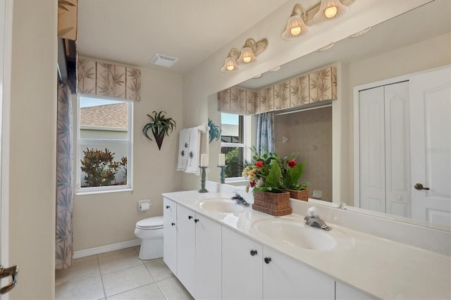 bathroom with tile patterned flooring, vanity, and toilet