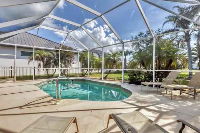 view of pool with a patio and glass enclosure