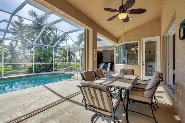 view of swimming pool with a patio, ceiling fan, and glass enclosure