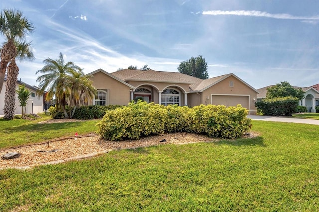 ranch-style house featuring a garage and a front yard