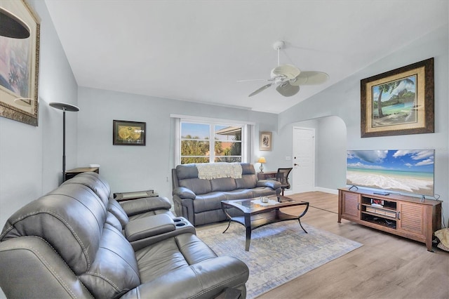 living room featuring ceiling fan, lofted ceiling, and light hardwood / wood-style floors