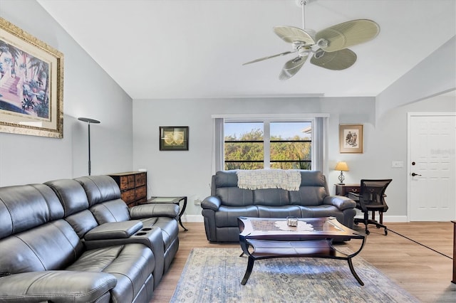 living room featuring lofted ceiling, hardwood / wood-style floors, and ceiling fan