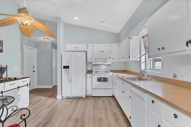 kitchen with sink, white appliances, white cabinetry, vaulted ceiling, and light wood-type flooring