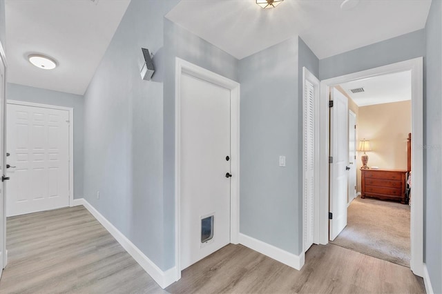 hallway with light wood-type flooring