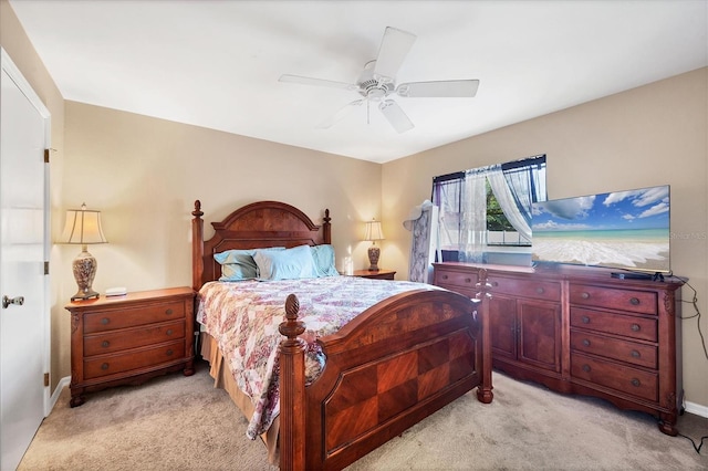 bedroom featuring light carpet and ceiling fan