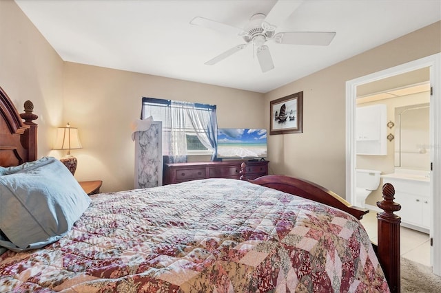 bedroom featuring connected bathroom, light colored carpet, and ceiling fan