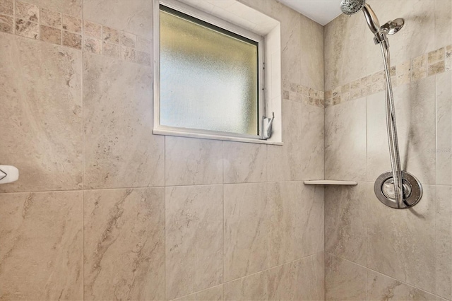 bathroom with tiled shower