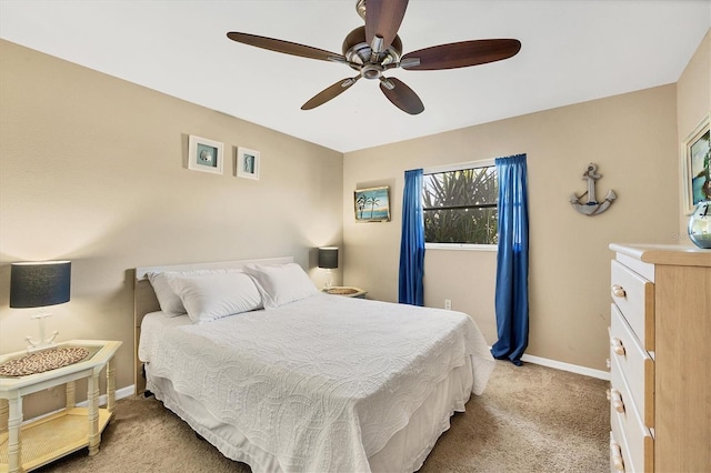 bedroom with ceiling fan and light carpet