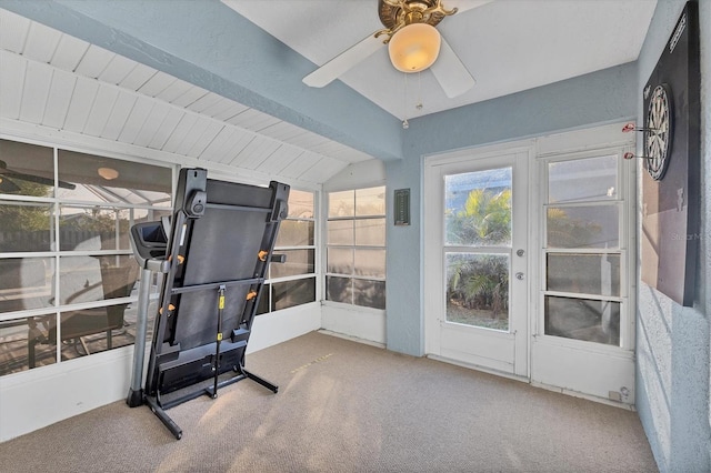 workout area with vaulted ceiling, ceiling fan, and carpet flooring