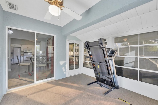 workout area featuring lofted ceiling, carpet floors, and ceiling fan