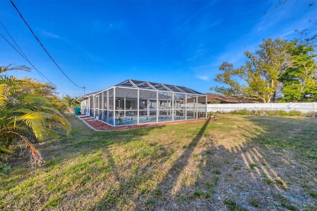 exterior space featuring a fenced in pool and glass enclosure