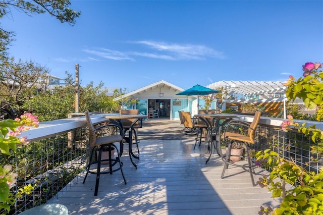 deck featuring a pergola and exterior bar