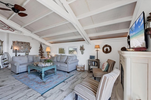 living room with ceiling fan, beam ceiling, and light hardwood / wood-style floors