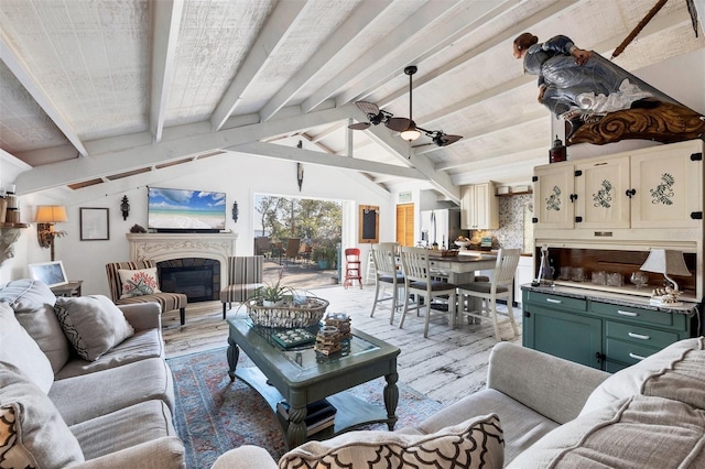 living room featuring vaulted ceiling with beams and ceiling fan