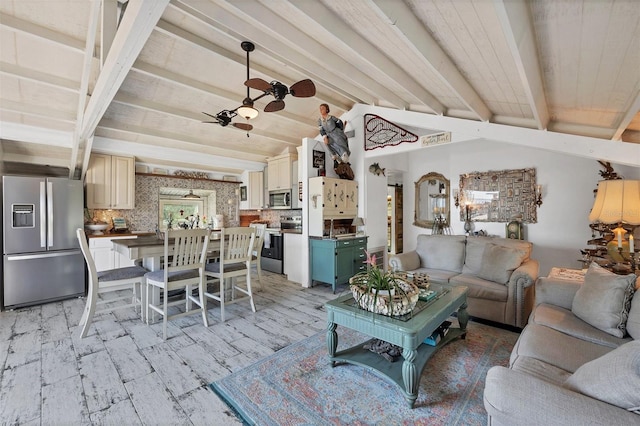 living room featuring ceiling fan, light hardwood / wood-style flooring, and vaulted ceiling with beams