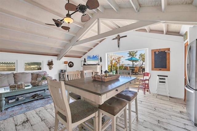 dining area with vaulted ceiling with beams, ceiling fan, and light hardwood / wood-style flooring