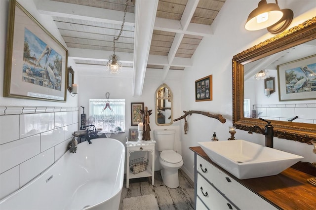 bathroom with vanity, a bath, beamed ceiling, wooden ceiling, and toilet