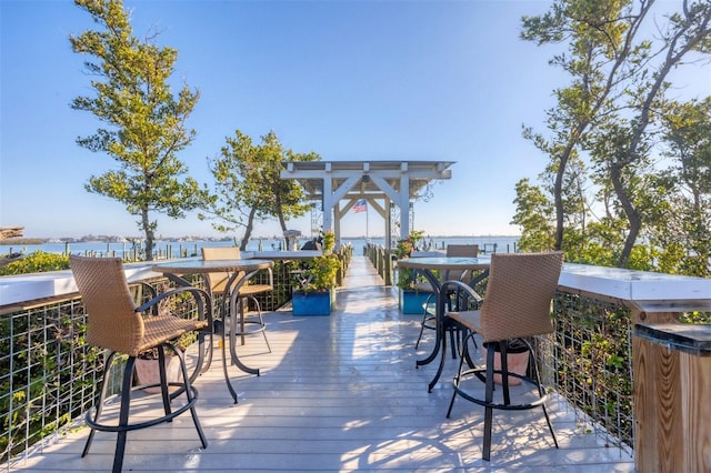 wooden terrace featuring a water view