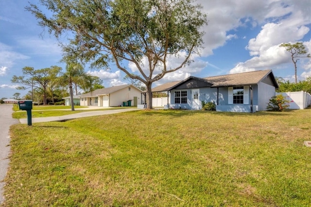 ranch-style home featuring a front yard