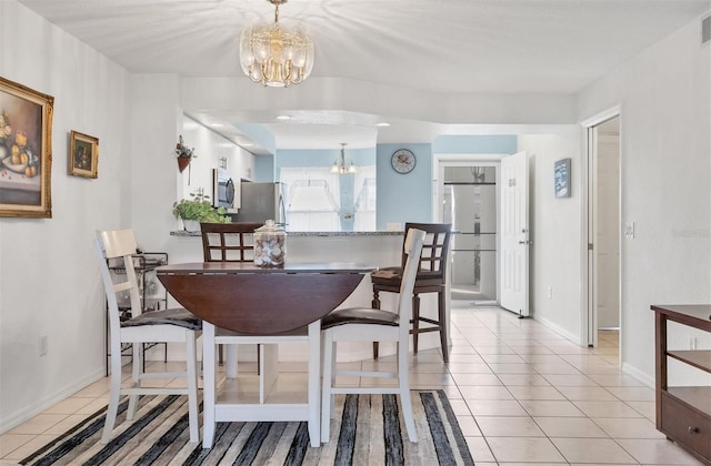 dining room featuring light tile patterned floors and an inviting chandelier