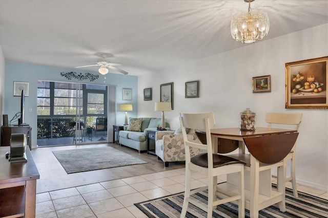 tiled living room featuring ceiling fan with notable chandelier