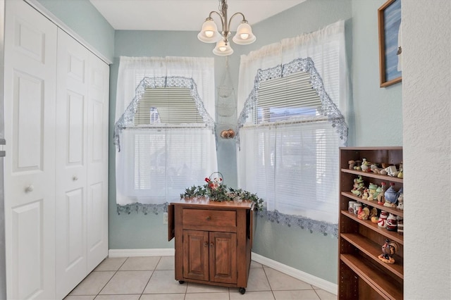 interior space with a notable chandelier and tile patterned floors