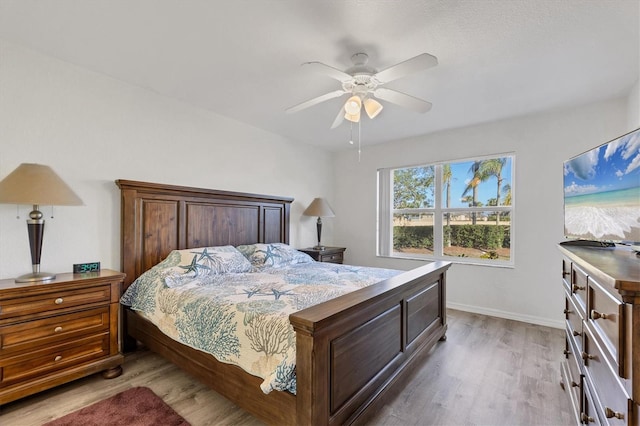 bedroom with ceiling fan and light wood-type flooring