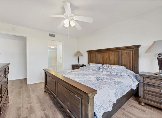 bedroom featuring ceiling fan, connected bathroom, and light hardwood / wood-style flooring