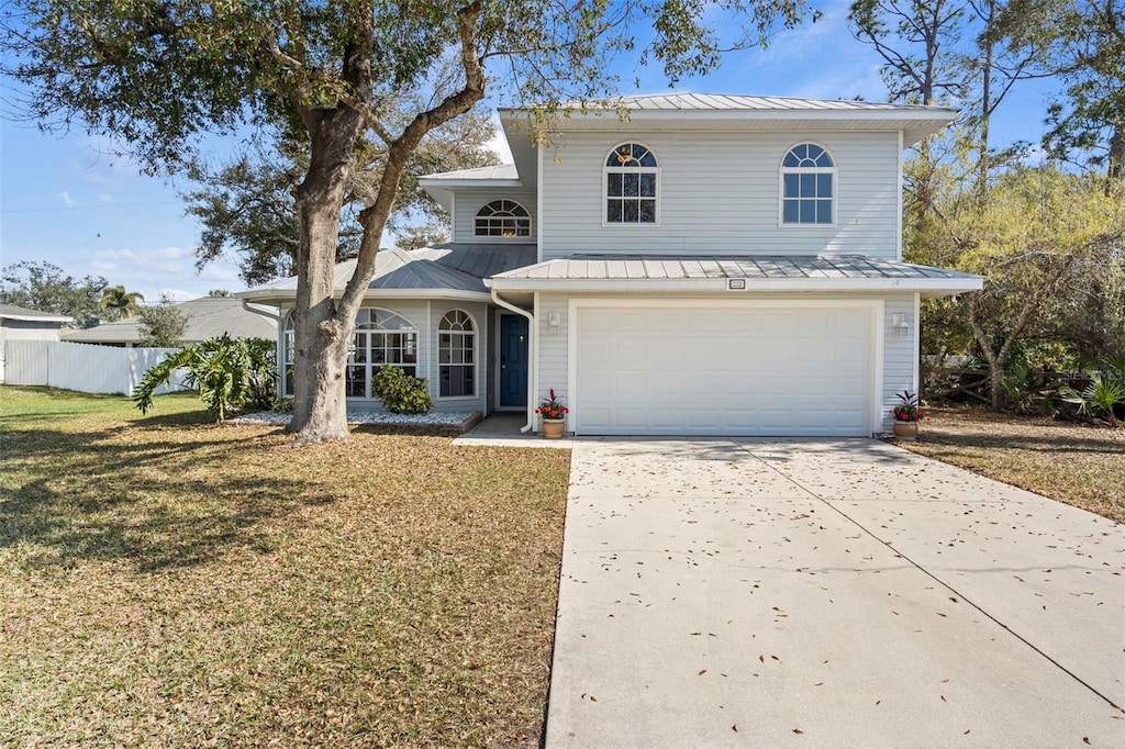 view of front property featuring a garage and a front lawn