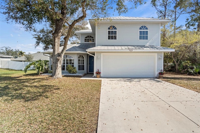 view of front property featuring a garage and a front lawn